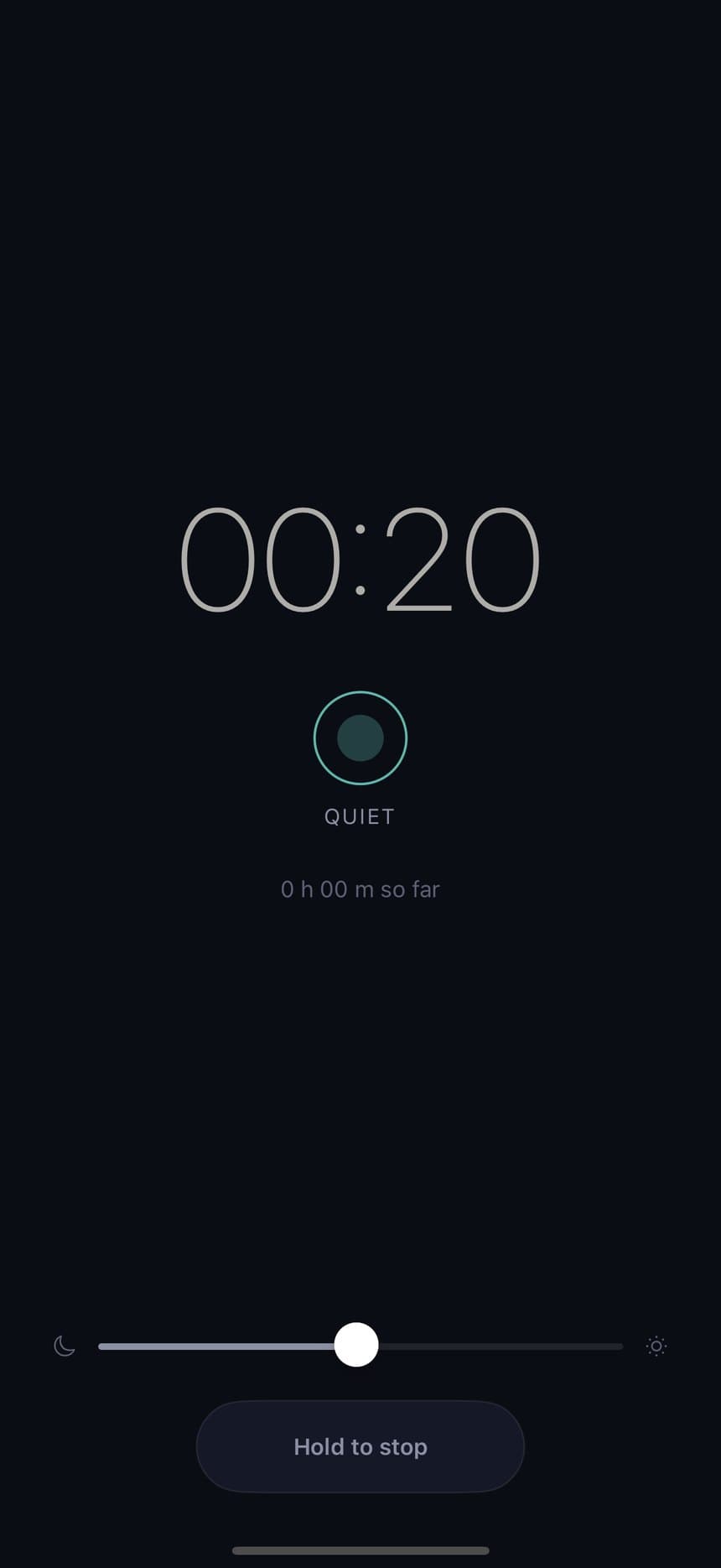 The bedside screen, dimmed to near-black, with a hold-to-stop bar.