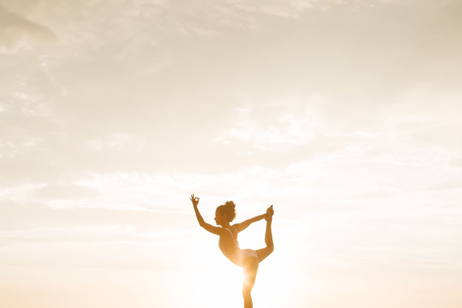 A dancer silhouetted in a golden-hour pose
