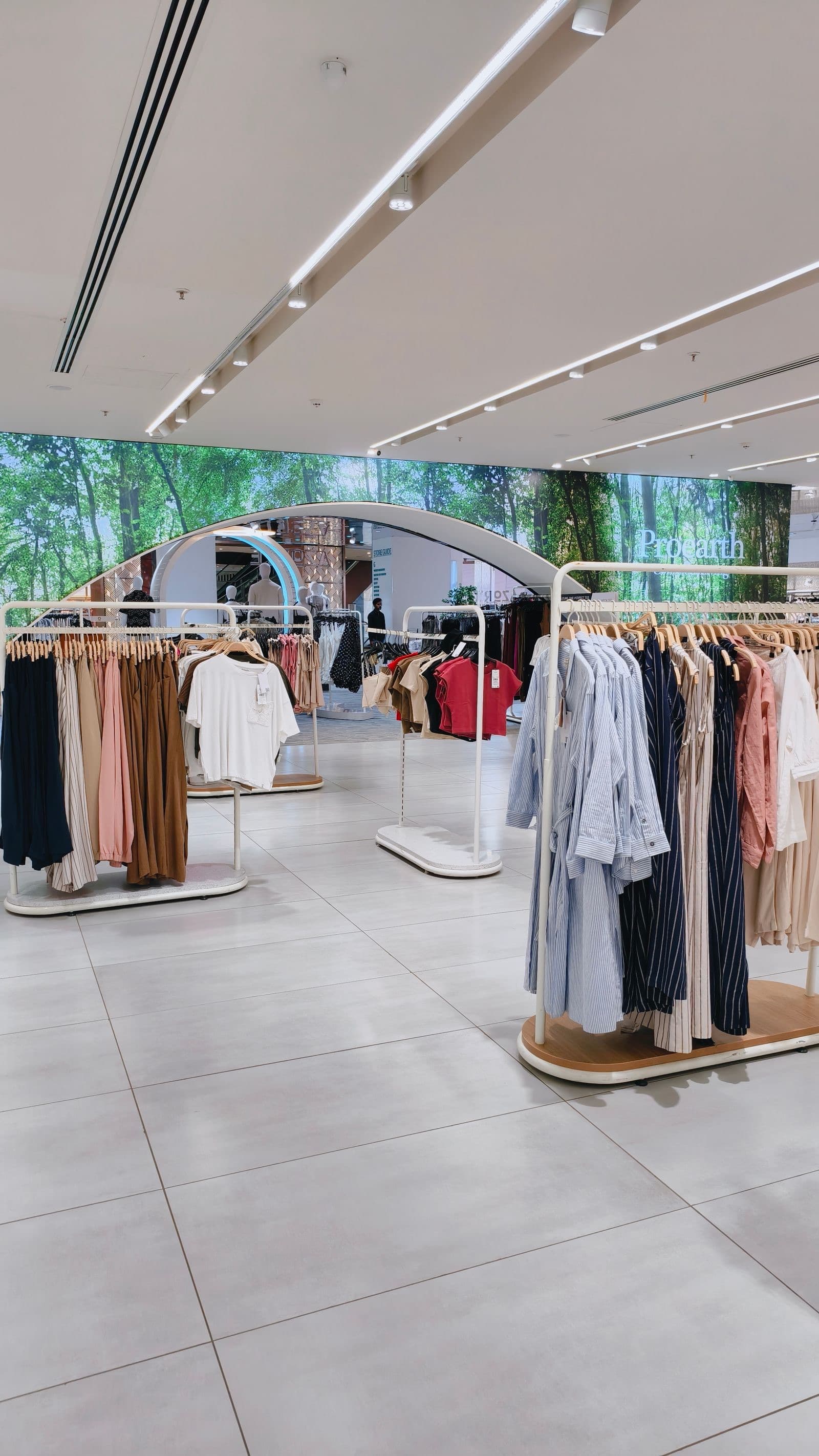 The boutique's bright shop floor with clothing on rails